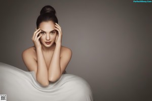 A woman in a black bra and panties posing for a picture.