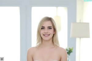 A woman in a white bikini posing for a picture.