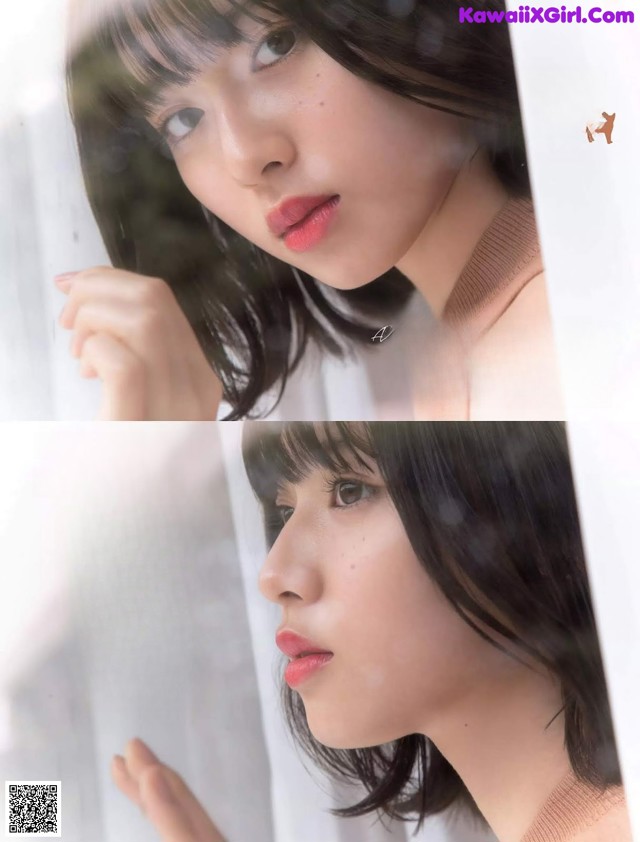 A woman with long black hair is looking out a window.