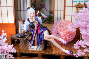 A woman sitting on a wooden bench with her legs crossed.