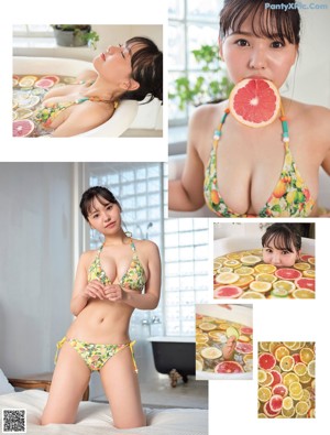 A woman in a bathtub holding a slice of grapefruit.