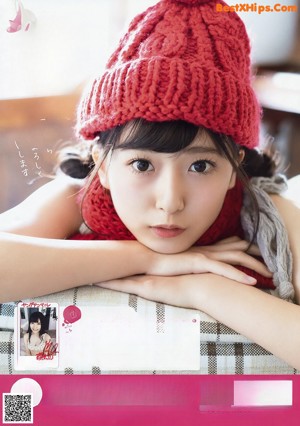 A woman wearing a red knitted hat and scarf.