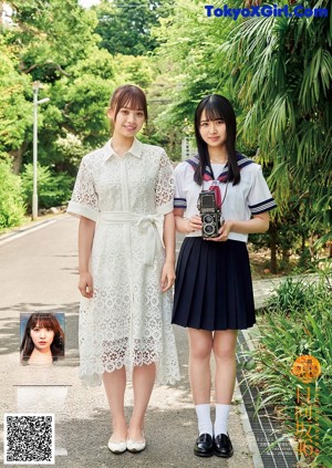 Two young women in school uniforms standing next to each other.