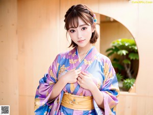 A woman in a pink kimono posing for a picture.