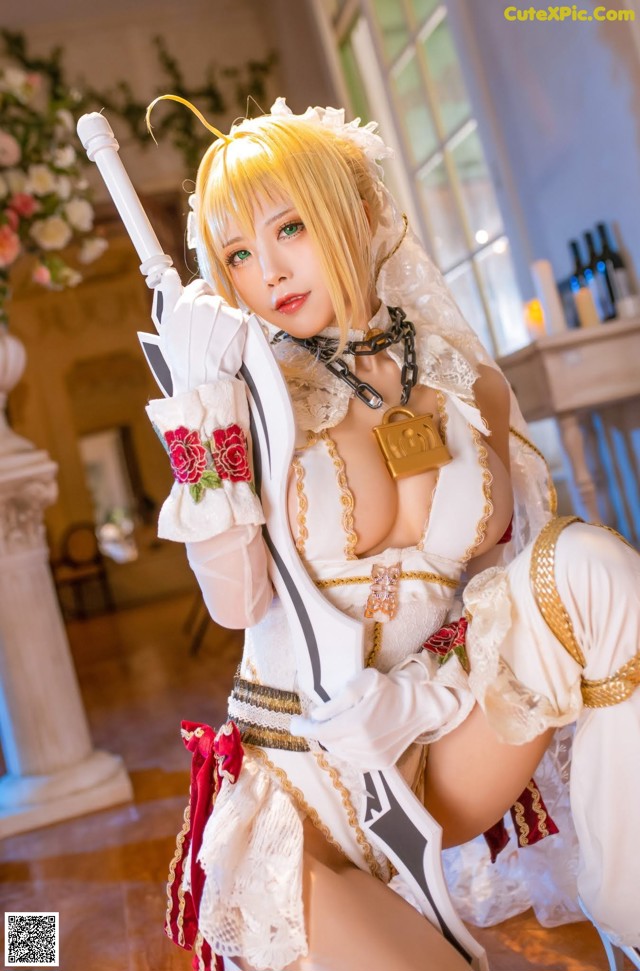 A woman in a white dress holding a sword.