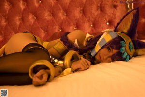 A woman laying on top of a bed in a costume.