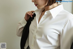 A woman in a white top and blue panties standing in a bathroom.