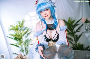 A woman in a blue and white dress posing for a picture.