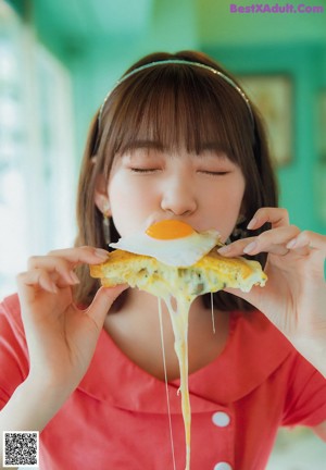 A woman sitting at a table with a plate of food.