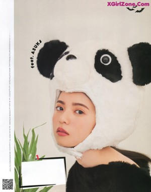 A magazine page with a picture of a woman wearing a cat mask.