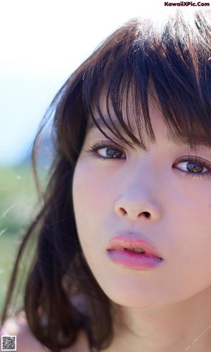 A woman with long black hair is posing for a picture.
