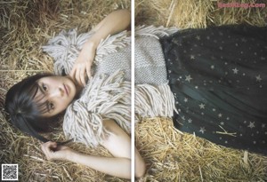 A woman sitting in a field of tall grass.