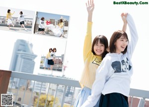 A couple of young women sitting on top of a bed.