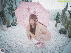 A woman in a pink bunny costume sticking out her tongue.