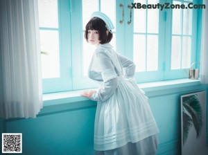 A woman sitting on top of a white chair.